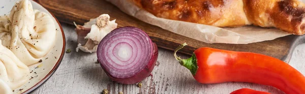 Vegetables with adjarian khachapuri and khinkali on table, panoramic shot — Stock Photo