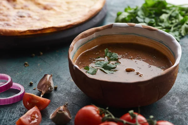 Soup kharcho with cilantro and imereti khachapuri at background — Stock Photo