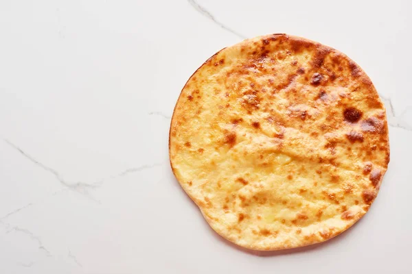 Top view of traditional Georgian imereti khachapuri on marble texture — Stock Photo