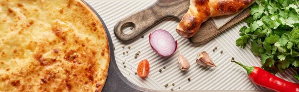 Adjarian and imereti khachapuri with vegetables and spices on textured background, panoramic shot — Stock Photo