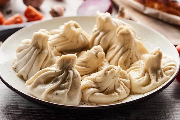 Delicious khinkali with black pepper on plate — Stock Photo