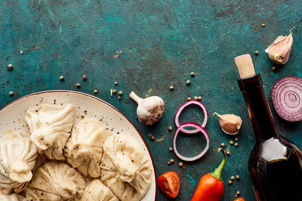 Vista dall'alto di deliziosi khinkali e vino con spezie su sfondo verde — Foto stock