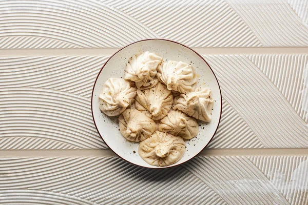 Top view of fresh delicious khinkali on textured beige background — Stock Photo