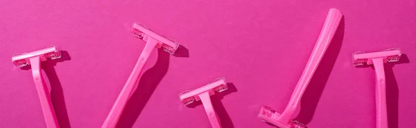 Top view of female disposable razors on pink background, panoramic shot — Stock Photo