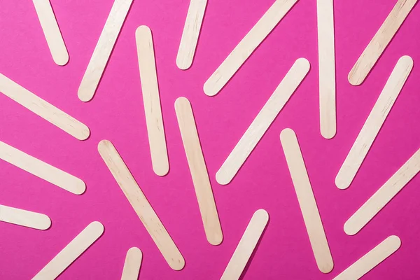 Top view of depilation wooden sticks on pink background — Stock Photo