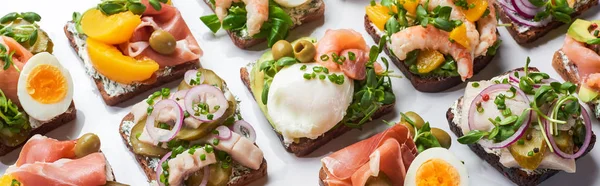 Panoramic shot of danish smorrebrod sandwiches on white — Stock Photo