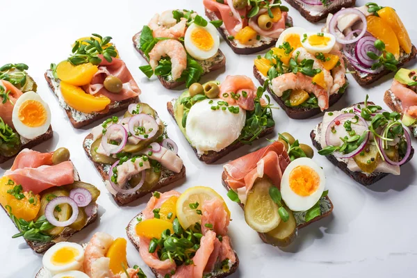 Danish smorrebrod sandwiches on white marble surface — Stock Photo
