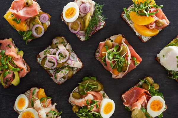 Top view of prepared danish smorrebrod sandwiches on grey surface — Stock Photo