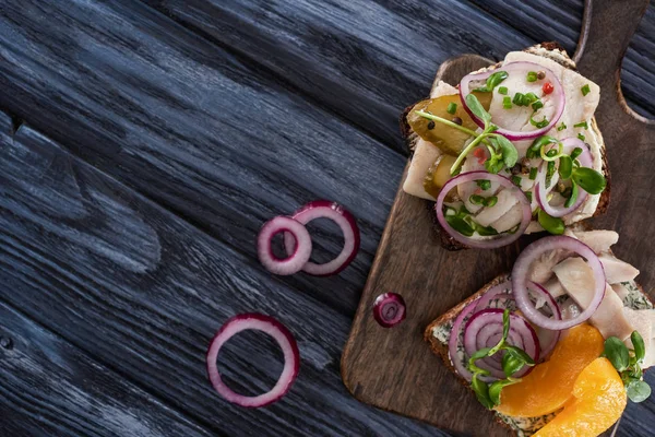 Top view of tasty smorrebrod sandwiches on blue wooden surface — Stock Photo