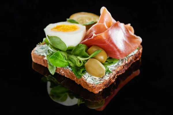 Close up of rye bread with tasty smorrebrod sandwich on black — Stock Photo