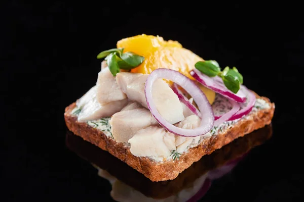 Fim de peixe de arenque em sanduíche de smorrebrod dinamarquês preparado em preto — Fotografia de Stock