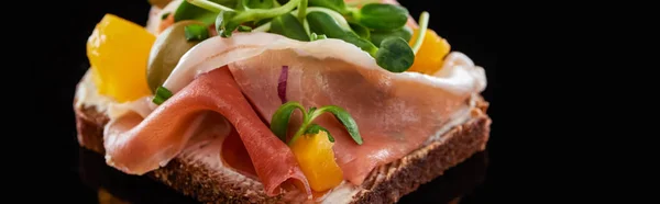 Panoramic shot of ham on prepared danish smorrebrod sandwich on black — Stock Photo