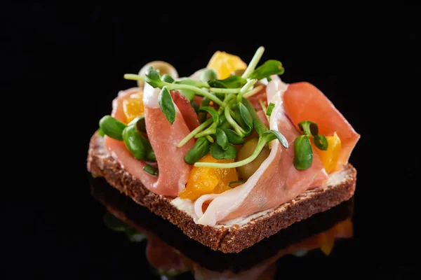 Close up of ham on cooked danish smorrebrod sandwich on black — Stock Photo