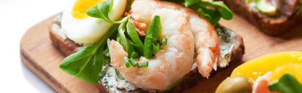 Panoramic shot of smorrebrod sandwich with tasty shrimps on white — Stock Photo