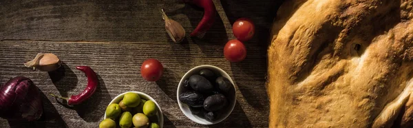 Top view of delicious pita, spices and olives on wooden rustic table, panoramic shot — Stock Photo