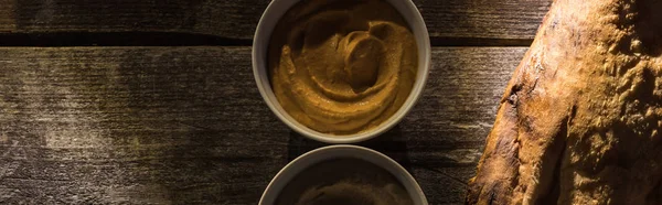 Top view of delicious assorted hummus and fresh baked pita on wooden rustic table, panoramic shot — Stock Photo