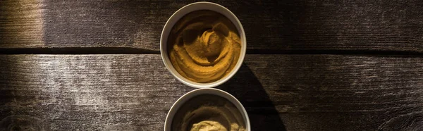 Top view of delicious assorted hummus on wooden rustic table, panoramic shot — Stock Photo