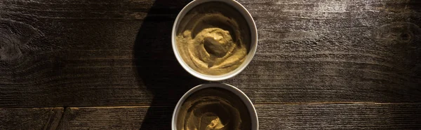 Top view of delicious assorted hummus on wooden rustic table, panoramic shot — Stock Photo