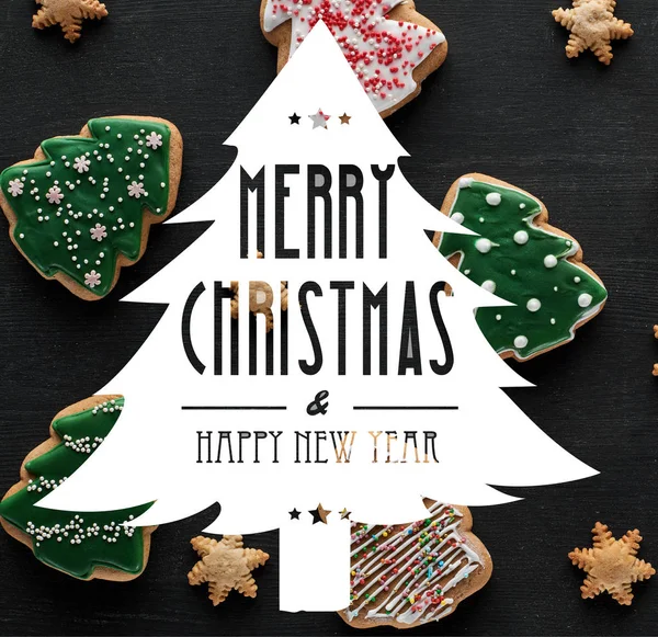 Delicious glazed Christmas cookies on black background with Merry Christmas and happy new year illustration — Stock Photo