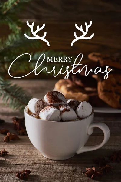 Selective focus of Christmas cacao with marshmallow on wooden table with merry Christmas lettering — Stock Photo