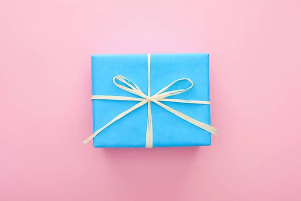 Top view of wrapped blue present on pink — Stock Photo