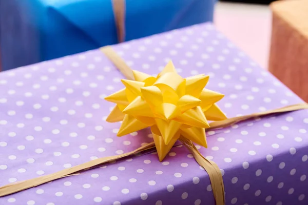 Selective focus of present with yellow bow — Stock Photo