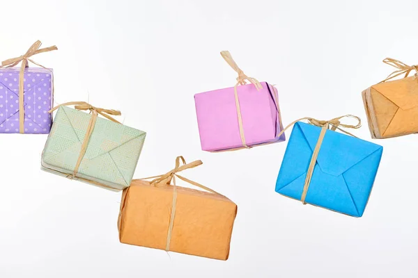 Falling colorful and wrapped presents isolated on white — Stock Photo