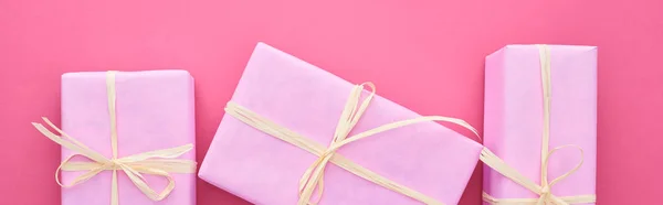 Panoramic shot of gift boxes with bows on pink — Stock Photo