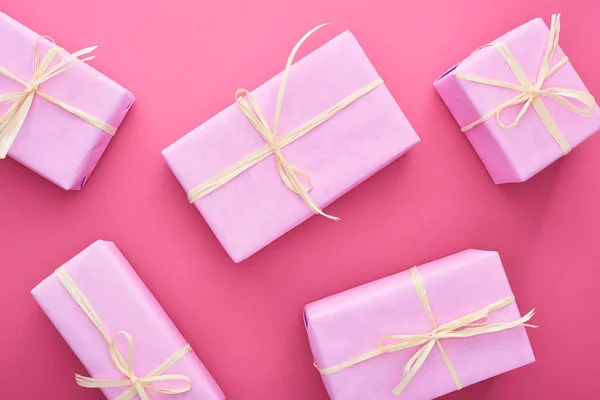 Top view of gift boxes with bows on pink — Stock Photo