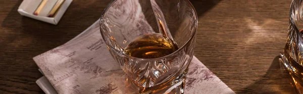 Verres Brandy avec carte et allumettes sur table en bois, vue panoramique — Photo de stock