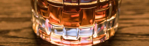 Close up view of brandy in glass on wooden table, panoramic shot — Stock Photo