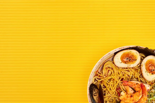 Top view of seafood ramen on yellow surface — Stock Photo