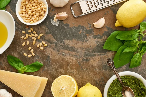 Top view of pesto sauce and ingredients on stone surface — Stock Photo