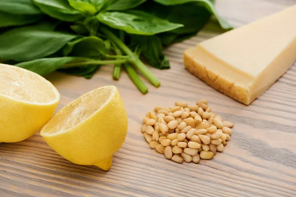 Close up view of pesto sauce raw ingredients on wooden table — Stock Photo