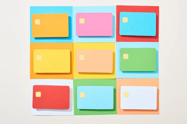 Top view of multicolored empty credit cards on grey background — Stock Photo