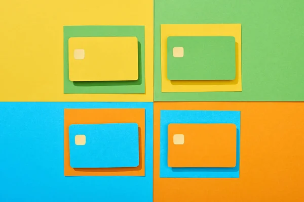 Top view of empty credit cards on green, orange, blue and yellow background — Stock Photo