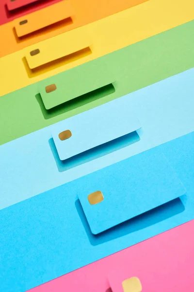 Tarjetas de crédito vacías multicolores sobre fondo de arco iris - foto de stock