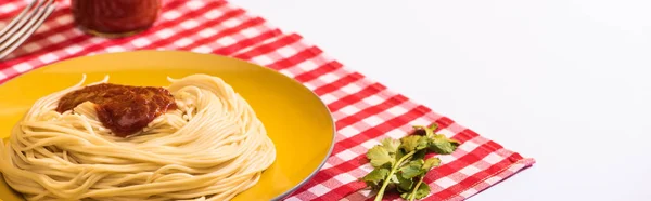 Panoramic shot of homemade spaghetti with tomato sauce beside cilantro on napkin on white background — Stock Photo