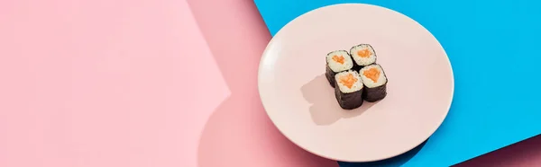 Maki fresco con salmón sobre fondo azul, rosa, plano panorámico - foto de stock