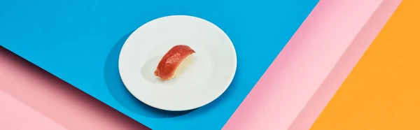 Fresh nigiri with tuna on blue, pink, orange background, panoramic shot — Stock Photo