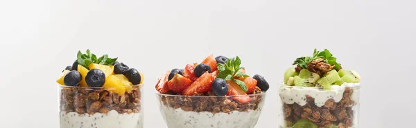 Fresh granola with fresh fruits and berries isolated on grey — Stock Photo