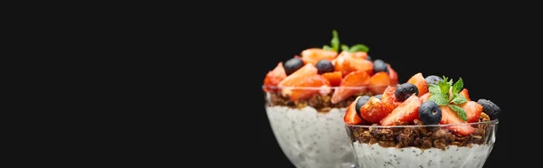 Selective focus of fresh granola with berries and chia seeds isolated on black, panoramic shot — Stock Photo
