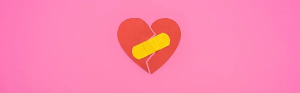 Top view of broken paper heart joined with patch isolated on pink background, panoramic shot — Stock Photo