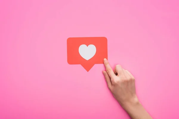 Partial view of woman holding paper like sign isolated on pink — Stock Photo