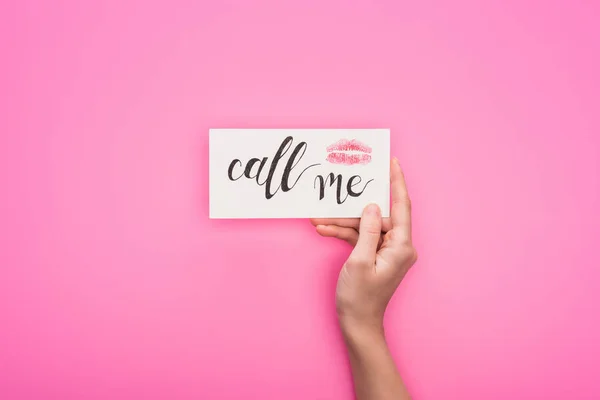 Cropped view of woman holding card with lip print and call me lettering isolated on pink — Stock Photo