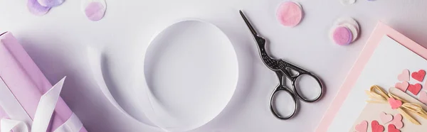 Top view of valentines gifts, ribbon and scissors on white background, panoramic shot — Stock Photo