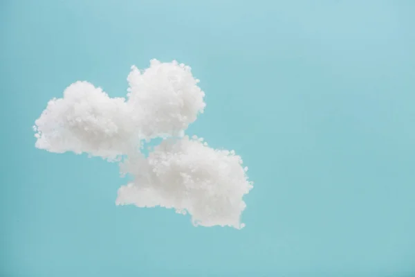 White fluffy clouds made of cotton wool isolated on blue background — Stock Photo