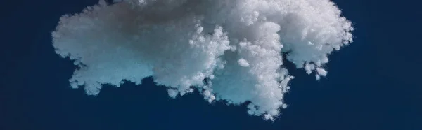 White fluffy cloud made of cotton wool isolated on dark blue, panoramic shot — Stock Photo