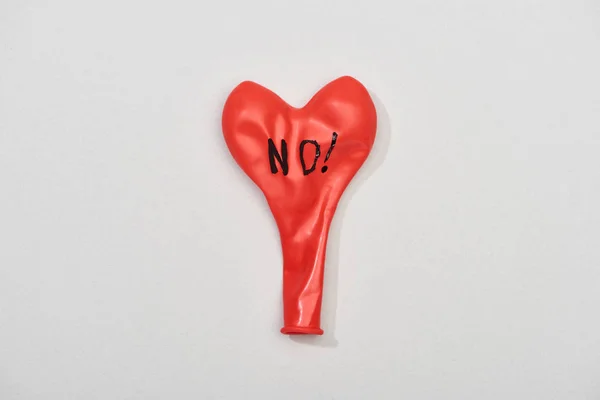 Top view of red rubber balloon with no lettering on grey background — Stock Photo