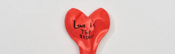 Top view of balloon with love is answer lettering on grey background, panoramic shot — Stock Photo